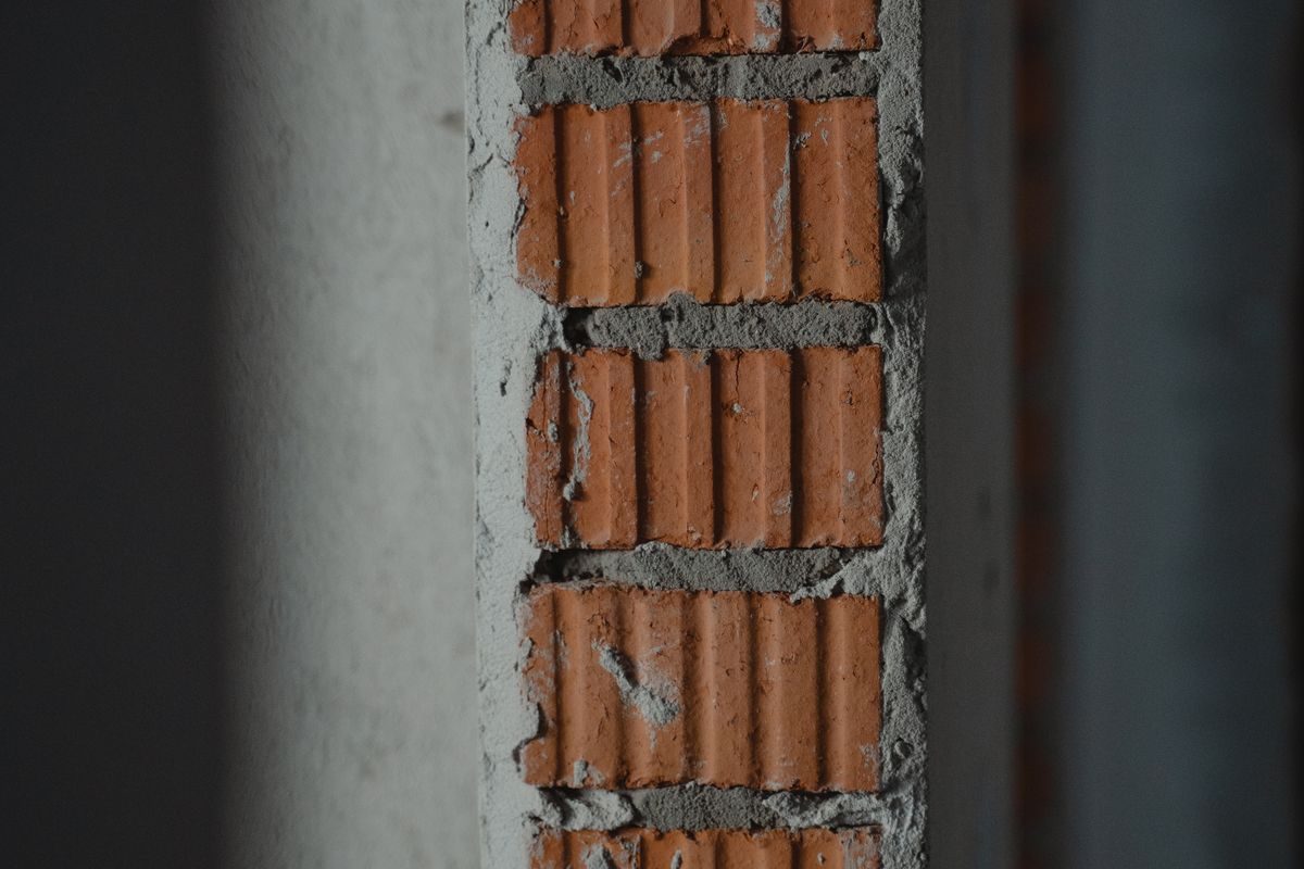 A bricklayer building a new brick wall